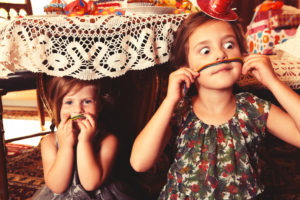 Party Girls eating sweet and sour candy spaghetti under the table Party Girls eating sweet and sour candy spaghetti under the table